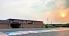 High school building with sunset and colorful pavement art.