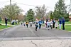 Children running on a street during a fun run event.