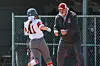 Coach celebrates with player in a softball game.