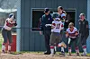 Softball team celebrating a home run.