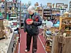 Woman in an antique shop looking at items.
