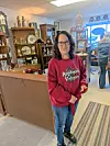 Customer in a vintage shop with antiques displayed.