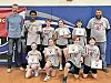 Youth sports team with certificates in a gym.