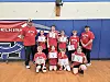 Youth basketball team with certificates in a gym.