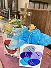 Easter gift bags with colorful designs on a church table.