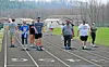 Participants walking on a track during a community event.