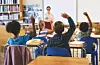 Students with raised hands in a classroom setting.