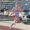 Athlete running with a pole on a track.