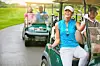 Group of golfers in carts on a golf course.