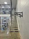 Interior staircase in a facility with metal railings.