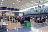 People gather in a school gym for a community event.