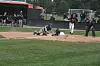 Baseball player sliding into home plate while catcher reaches for the ball.