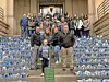 Group photo on courthouse steps with blue pinwheels.