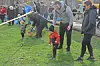 Children collecting eggs during an outdoor egg hunt.