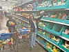 Child and adult in a toy aisle with stuffed animals.
