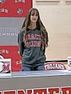 Student in Grace College sweatshirt at signing event.