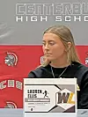 Lauren Ellis at a signing ceremony with a nameplate in front of her.