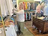 Woman organizing clothes in a boutique.