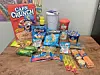 Assorted snacks and cereals on a wooden table.
