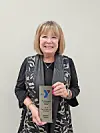 Melody Rader holding an award from the Y.