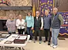 Lions Club members standing together in a meeting space.