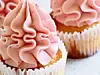 Close-up of cupcakes with pink frosting.