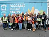 Group of volunteers in front of a food bank pop-up pantry truck.