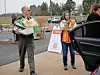 Volunteer carrying food boxes at a distribution event.