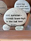 Decorative stone with text about summer and weeds.