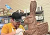 Chocolatier working on a large chocolate bunny sculpture.