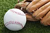Baseball and glove on grass
