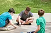 Children drawing with chalk on the pavement.