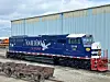 Blue Americo locomotive in a rail yard.