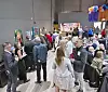 People mingling at an art event with colorful decorations.