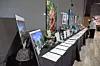 Artworks and displays on a table at an event.