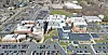 Aerial view of a large campus with buildings and parking lots.