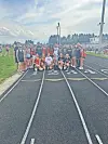 Track team members posing on the track.