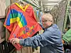 Person displaying a rainbow-themed scout garment in storage.