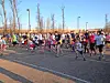 Runners of various ages starting a fun run in a sunny outdoor setting.