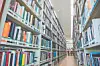 Aisle in a library lined with bookshelves filled with books.