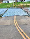 Flooded road with visible water covering the pavement.
