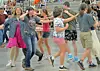 Group of people dancing in a community hall.