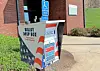 Ballot drop box with patriotic design outside a building.