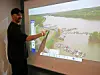 Instructor points at a marina layout on an interactive display.