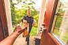Delivery person handing a package at the door.