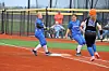 Softball players in blue uniforms at first base.