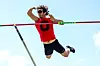 Athlete jumping over a pole vault bar.