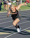 Athlete sprinting on a track in a black and orange uniform.
