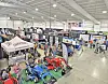 Aerial view of a trade show with booths and agricultural machinery.