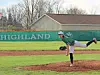 High school baseball pitcher in mid-throw on the field.